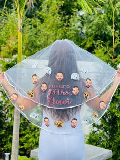 the back of a woman's head wearing a veil with pictures of people on it