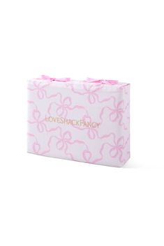 a pink and white box with bows on the top that says lovesick fancy in gold lettering