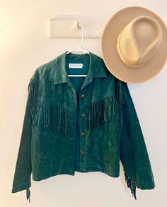 Size M, emerald green southwestern fringe jacket. This jacket is so soft as it is 100% rayon. There is an embroidered pattern all over this jacket with fringe on the arms, chest and back. No flaws noted on the fringe. This is such a beautiful piece! Approximate measurements: pit to pit 19 inches, shoulder to waist 20 1/2 inches, shoulder to wrist 22 inches. Long Sleeve Outerwear With Tassels For Rodeo, Fringe Long Sleeve Outerwear For Rodeo, Long Sleeve Fringe Outerwear For Rodeo, Fitted Casual Outerwear With Tassels, Casual Fitted Tasseled Outerwear, Western Long Sleeve Outerwear With Tassels, Western Style Long Sleeve Outerwear With Tassels, Bohemian Fringe Outerwear For Rodeo, Womens Jackets