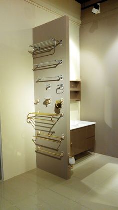 a bathroom with a wall mounted towel rack and toilet paper dispenser in it