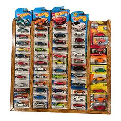 hot wheels display case in wooden frame with 6 cars on each shelf and 4 different colors