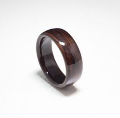 a wooden ring sitting on top of a white surface