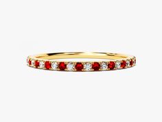 a yellow gold band with red and white stones