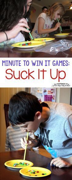 two children are playing with paper plates on the table and one boy is writing something