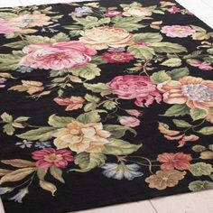 a black rug with colorful flowers on it