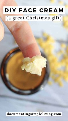 An overhead shot of a light finger with homemade anti-wrinkle face cream on it. There's an amber glass jar underneath the finer with beeswax around the jar. Diy Face Cream