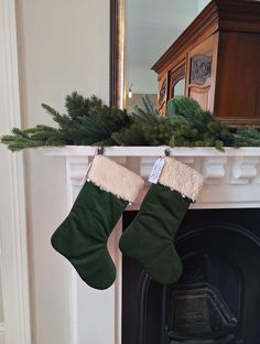 a fireplace with stockings hanging from it's mantle