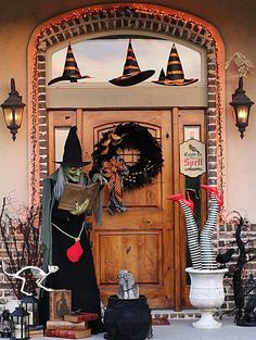 a front door decorated for halloween with decorations