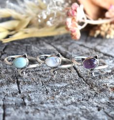 Cat Ring Details:-Choice of Natural Rainbow Moonstone, Dominican Larimar, or Natural Amethyst- 12mm face height- 2mm smooth round band- .925 solid sterling silver- Available in US ring sizes 4-10.5 with 1/2 sizes. 💜Connect with us on Instagram @a_wild_violet for sales and giveaways!**All items are in stock and ship within 2-5 business days from received payment (excluding Saturday/Sunday) from the US. If you are within the US please expect 3-7 business days for shipping transit and delivery. In Dainty Round Gemstones For Jewelry Making, Sterling Silver Stackable Rings With Natural Stones, Round Dainty Gemstones For Jewelry Making, Amethyst Ring With Natural Stones For Healing, Silver Stackable Rings With Natural Stones, Spiritual Style Stackable Rings With Natural Stones, Adjustable Amethyst Ring With Natural Stones, Dainty Moonstone Ring With Natural Stones, Dainty Round Moonstone Ring With Natural Stones