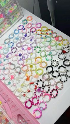 a table topped with lots of different types of bracelets and hair clips on top of it