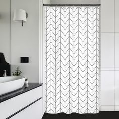 a black and white bathroom with a shower curtain