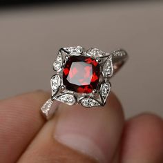 This is a gorgeous handmade creation. Its beauty is its simplicity & Elegance. The 7*7 mm cushion shape faceted natural garnet is crafted in solid sterling silver and with rhodium plated. All item is sent in a beautiful gift box If you have any idea of design your ring,pls contact me directly. You can realize more lovely stuff clicking the link https://www.etsy.com/shop/knightjewelry?refshopsection_shophome_leftnav Please leave the correct address and you phone number for delivering successf Cushion Cut Ruby Jewelry Gift, Cushion Cut Ruby Jewelry As Gift, Cushion Cut Ruby Jewelry For Gift, Elegant Cushion Cut Ruby Promise Ring, Red Cushion Cut Center Stone Jewelry, Red Square Cut Gemstone Jewelry, Red Cushion Cut Gemstone Ring, Elegant Silver Ruby Ring With Cushion Cut, Red Cushion Cut Ring With Accent Stones