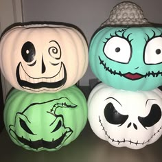 three pumpkins with faces painted on them