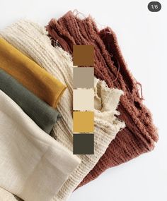 four different colors of scarves on top of each other