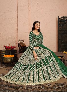 Dark Green Golden Zari Embellished Designer Anarkali Suit features a beautifully embellished attire with all the details of golden zari, thread and stone work in traditional kali patterns on soft net anarkali top paired with solid santoon bottom and zari border and butti embellished soft net dupatta. Style this set on any asian bridal or festive party with statement jewellery and heels to look stunningly gorgeous. This set comprises of an anarkali gown, pants bottom and a dupatta. Embroidery wor Long Anarkali Dress, Dress Anarkali, Green Anarkali, Long Anarkali, Designer Anarkali Suits, Gown Suit, Gown For Women, Indian Salwar Kameez, Designer Anarkali