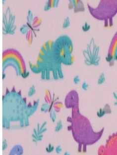 an image of children's fabric with dinosaurs and rainbows