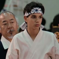 two people standing next to each other wearing headbands and hair clips on their heads