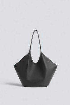 Black phantom tote. large carry-all tote featuring a dramatic and fluid silhouette. crafted in italian calfskin with central magnetic closure and internal pocket.    - 100% grain calfskin    - lining: 100% polyester    - dimensions in cm: h 42.2cm w 27.5cm d 17cm    - handle drop: 32cm Fish Candle, Womens Designer Bags, Four Horsemen, Womens Tote, Magnetic Closure, Womens Tote Bags, Neon Pink, Calf Skin, Bags Designer