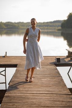 "This striped summer dress is tailored from light soft natural linen. You can wear it two ways - tied at the back for a fitted look or tied at the side for a more relaxed look.  It has side seam pockets for your convenience. Just a perfect dress for a beach or hot day in the city. The model is wearing a blue-white striped dress. 100 % washed Lithuanian linen. SIZE CHART:  XS-4 US/ 6UK/ 36 EU: Bust 33\" (84 cm) , Waist 25\" (63,5 cm), Hips 36\" (92 cm)  S-6 US/ 8UK/ 38 EU: Bust 35\" (88 cm) , Waist 26,5\" (67,5 cm), Hips 38\" (96 cm) M-8 US/ 10UK/ 40 EU: Bust 36\" (92 cm), Waist 28\" (72 cm), Hips 39\"(100 cm) L-10 US/ 12UK/ 42 EU: Bust 38,4 \" (96 cm) , Waist 30,4\" (76 cm), Hips 41,6\" (104 cm) XL-12 US/ 14UK/ 44 EU: Bust 40\" (100cm) , Waist 32,8\" (82 cm), Hips 43,2\" (108 cm) If you ar Striped Linen Dresses For Vacation, Striped Linen Dress For The Beach, Summer Striped Linen Dress, Striped Linen Summer Dress, Striped Linen Beach Dress, Chic Striped Linen Dress, Linen V-neck Wrap Dress For Spring, Beach Linen Wrap Dress, Midi Length, Summer Linen V-neck Wrap Dress