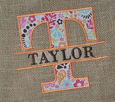 the word taylor is embroidered onto a burlocked piece of fabric with flowers and leaves