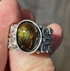 R1548- Handmade Sterling Silver 13 x 10 mm Free form Fire Agate ring, Size 7 1/2, I can size it to fit, just contact me. No charge to size down. Unique design is One of a Kind made by me from start to finish. The scroll and bead design gives this ring and most of my designs and Victorian or Egyptian feel. ** Stone is not set yet to make it easier to size**. The top of the ring measures 15 mm and the band 4 mm. This ring is made by the Lost wax Casting method, where I make the design in wax and then cast it into silver. Thanks for visiting, If you have any questions please feel free to contact me. Patti Artisan Amber Gemstone Rings, Collectible Iridescent Cabochon Jewelry, Unique Oval Iridescent Jewelry, Unique Iridescent Oval Jewelry, Iridescent Oval Spiritual Rings, Spiritual Iridescent Oval Rings, Artisan Oval Opal Ring Gift, Unique Handmade Iridescent Opal Ring, Iridescent Oval Cabochon Ring