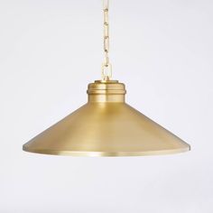 a brass colored light hanging from a chain