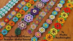 beaded bracelets with flowers and leaves on them sitting on a wooden table next to each other