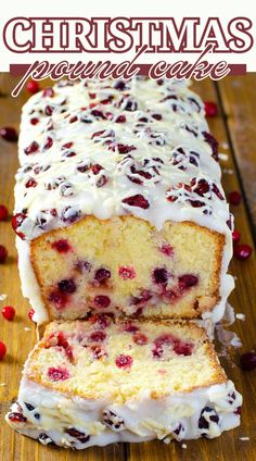 a loaf of cranberry christmas pound cake on a cutting board with white icing