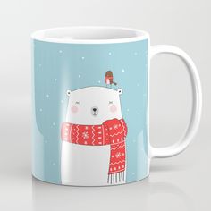 a white coffee mug with a polar bear wearing a red scarf