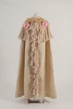 House of Worth, c 1900. Cream and pink silk opera cloak with lace and chiffon collar. Worn by Mary Chamberlain. Fashion Museum Bath. Luxury Historical Victorian Dress For Theater, Theater Vintage Victorian Dress With Historical Design, Vintage Baroque Victorian Dress For Theater, Regency Cloak, Ethereal Clothes, Historical Dressing Gown, Worth Dresses, Fashion Museum, House Of Worth