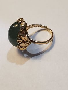 You are viewing a beautiful 14k mings green translucent jade cabochon ring. The total weight of the ring is approx.8.6 grams. The ring size approx.5 3/4 can size up or down. The ring itself measures approx.21mm x 19mm wide. Beautiful green jade translucent cabochon. Send me a message if you have any question. MAKE AN OFFER Yellow Gold Jade Cabochon Ring, Yellow Gold Jade Ring With Gemstone, Oval Jade Rings In Yellow Gold, Yellow Gold Jade Jewelry With Cabochon, Green Oval Cabochon 14k Stamped Jewelry, Gold Jade Cabochon Rings, Jade Rings With Polished Finish, Oval Cabochon, Jade Rings With Polished Finish In Oval Cabochon Shape, Gold Rings With Jade Cabochon