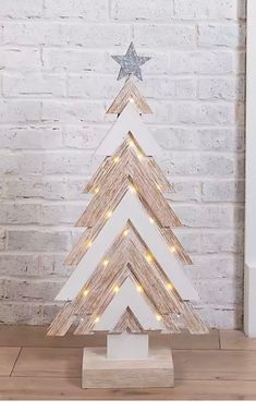 a wooden christmas tree with lights on it