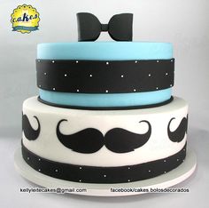 a three layer cake decorated with mustaches and bow ties