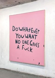 a pink sign that says do whatever you want no one gives a f k