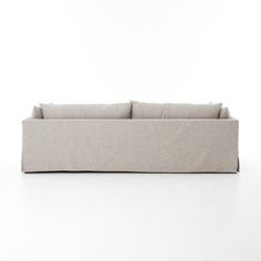 a white couch sitting on top of a white floor