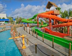 an outdoor water park with slides and swimming pool