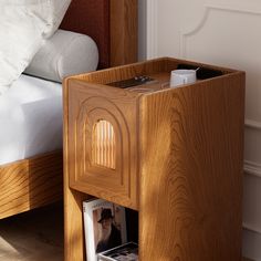 a bed with a wooden headboard and night stand