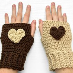 two crocheted gloves with hearts on them, one is brown and the other is beige