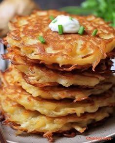 stack of potato pancakes with sour cream on top