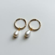 These 18K gold plated stainless steel hoop earrings are perfect for any occasion - durable, hypoallergenic, and tarnish-resistant, they feature a pearly white freshwater rice pearl pendant. The 19 gauge posts provide a secure fit, and the pearls vary from 9-10mm for a subtle, stylish touch.