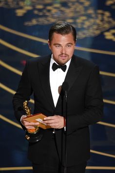 the actor is holding an award in his hand