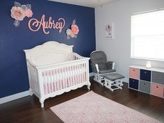 a baby's room with blue walls and pink accents