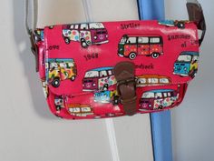 "Here is a great shoulder bag for the lover of the VW Campervan. It is made of bright shocking pink vinyl fabric which is decorated in colourful VW camper van motifs and little sayings, or slogans, reflecting the 1968 \"Summer of Love\" and \"Woodstock\" There is no manufacturer's tag anywhere nor any sign of one. I think it could have been made up to about 20 years ago. The bag has a magnetic popper opening which is made of faux leather and a brass-like metal. It's tight fitting so should not be \"yanked\" to open the flap. On the back the bag has a zipped pocket. The zip is pink. The pocket is lined. Under the bag's closing flap is another pink zip which opens the main part of this shoulder bag. The interior is lined with a nylon fabric which has a zipped pocket and two other pockets. Th Retro Pink Shoulder Bag With Adjustable Strap, Pink Retro Shoulder Bag With Adjustable Strap, Retro Pink Shoulder Bag For Daily Use, Vintage Pink School Bag, Pink Vintage School Bag, Retro Pink Satchel Shoulder Bag, Pink Retro Satchel Shoulder Bag, Retro Pink Shoulder Bag For Everyday Use, Retro Pink Shoulder Bag As Gift