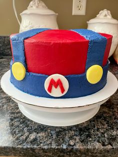 a cake that is shaped like a train on top of a plate with the letter m on it