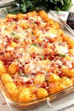 a casserole dish with cheese and meat in it sitting on a counter top