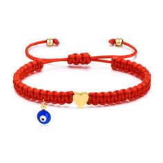 a red bracelet with an evil eye charm and a gold plated heart on it