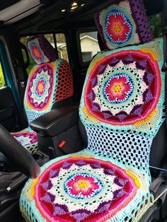 there is a crocheted blanket in the back seat of a car with two seats