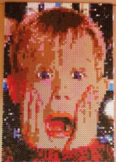 a close up of a lego photo of a child's face on a wall