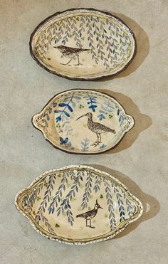 three decorative bowls with birds painted on them