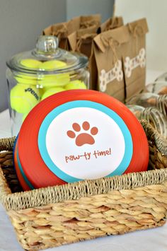 a basket filled with frisbees and other items on top of a table